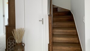 A staircase with wooden steps leading to a white door.