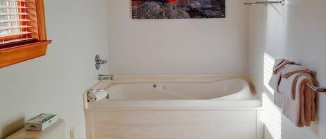 A bathroom with a bathtub, toilet, and sink.