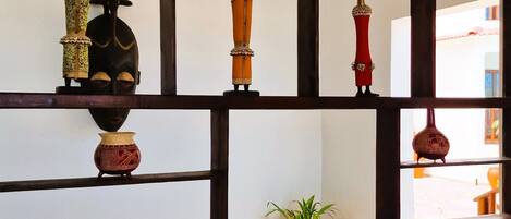 A room with a wooden bookshelf containing various decorative items.