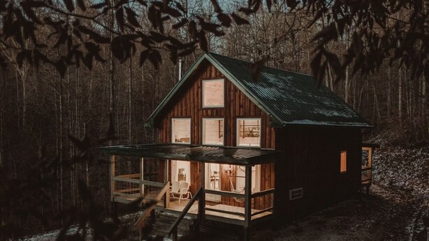 A cabin with a porch, a staircase, and a small adjacent shed. - Secluded 12-Acre Retreat w/ Hot Tub, Mountain Views, Arcade - Red River Gorge (Campton)