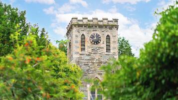 A stone clock tower with a clear sky in the background.