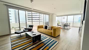 Business Apartment | Living area | 60-inch LED TV with digital channels, Netflix, Hulu