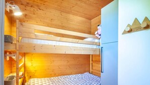 A bunk bed room with a wooden ceiling, a refrigerator, and a wall decoration. - Ground floor, view mountain, balcony, parking, tv, 64m², Morzine (Morzine)