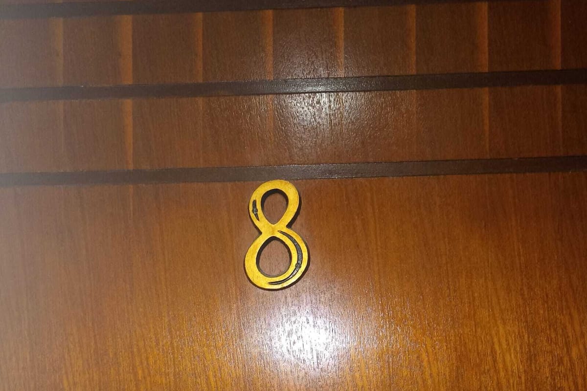 A wooden surface with a number "8" and horizontal lines.