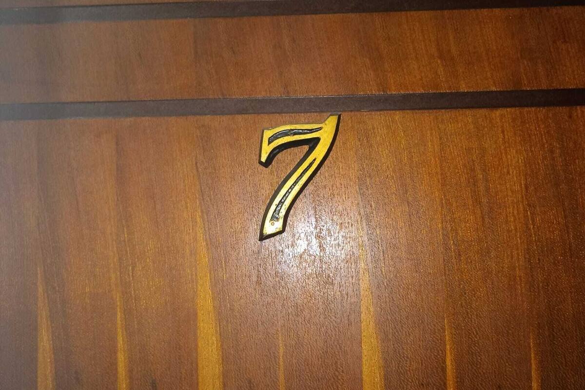 A wooden floor with a number 7 sticker.