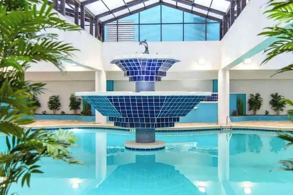 Dive into relaxation at our indoor pool, an aquatic sanctuary with a striking fountain centerpiece.