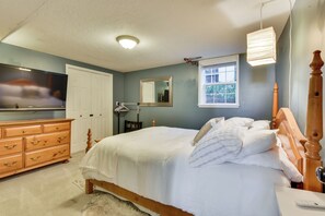 A bedroom with a bed, dresser, TV, and a window. - Lovely Salt Lake City Cottage w/ Outdoor Space! (Salt Lake City)