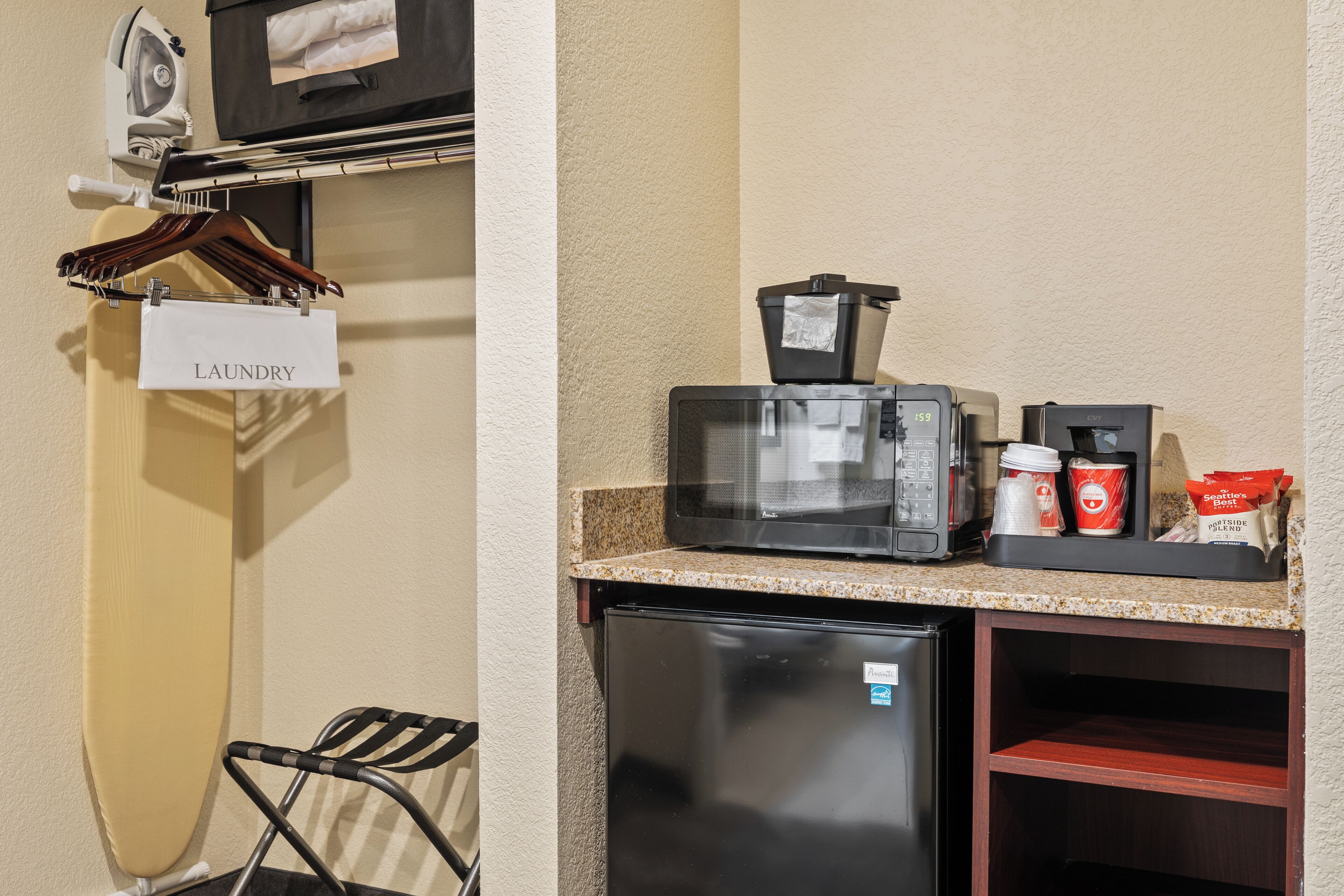 A compact kitchenette with a microwave, coffee maker, and a refrigerator.