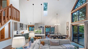 A spacious living area with a sofa, a dining table, and a kitchen in the background. - Bryce Resort | Hot Tub | Game Room | Sleeps 12 (Basye)