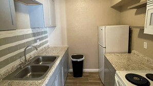 A compact kitchen with a sink, stove, and refrigerator. - 🤩⭐️fully updated apartment northeast⭐️🤩 (El Paso)