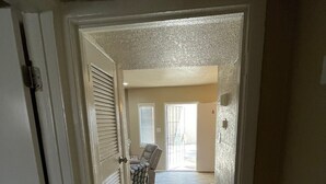 A hallway with a tiled floor leading to a door with a window. - 🤩⭐️fully updated apartment northeast⭐️🤩 (El Paso)