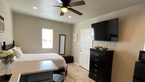 A compact kitchen with a central island, a ceiling fan, a built-in TV, and a small trash bin. - ⭐️Private stand-alone studio Central⭐️ (El Paso)