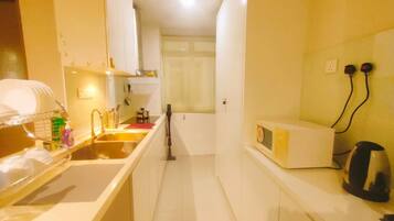 Fridge, microwave, electric kettle, cookware/dishes/utensils