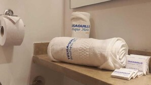 Un baño con un sujetapapeles, una toalla y un espejo.