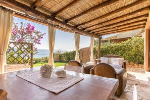 Outdoor dining - LUNA BAY HOME RETREAT with a view of Porto Luna Bay, 2 km from Villasimius (VILLASIMIUS)