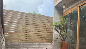 Una piscina con cubierta de madera y una planta en maceta.
