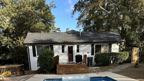 A rectangular swimming pool with a wooden deck and a house in the background. - Fantastic Master’s Rental- 1 mile away! (Augusta)