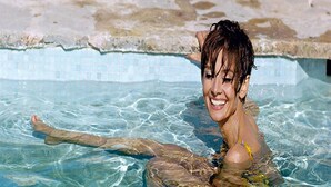 A person in a swimming pool with clear water and a tiled edge. - Iconic Mid-Century Modern Gem – Featured on Palm Springs Modernism Week Tour! (Palm Springs)