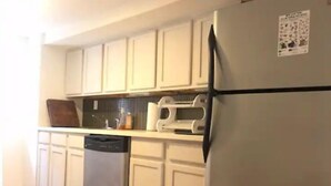 A kitchen with white cabinets, a dishwasher, and a refrigerator. - SPIFFY PRIVATE APT. WILLIAMSBURG PRIME BROOKLYN (Brooklyn)