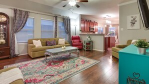 A living room with a sofa, coffee table, and a patterned rug. - Patio, Pergola & Pool Access: Aubrey Retreat! (Aubrey)