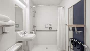 Ein modernes Badezimmer mit Dusche, Waschbecken und Handtuchhalter.