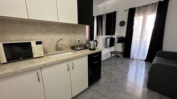 Basic Studio Suite | Private kitchen | Full-size fridge, microwave, oven, stovetop