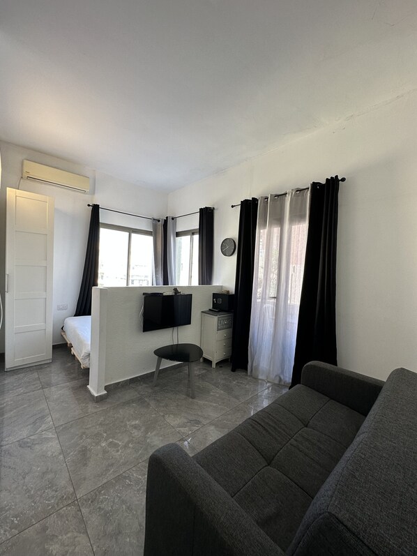 Basic Studio Suite | Living area | 50-inch Smart TV with cable channels - Ha-Yarkon Thirty Nine (Tel Aviv)