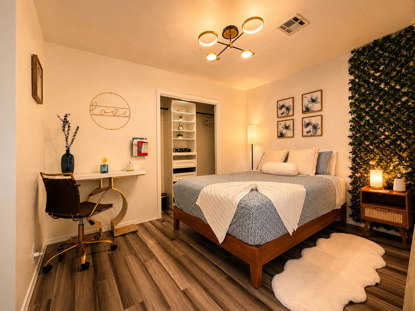 A bedroom with a bed, desk, chair, and a closet.