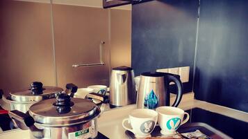 Fridge, electric kettle, cookware/dishes/utensils, dining tables