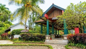 A building with a sign for a restaurant and a sign for rooms and a swimming pool. - Margo Utomo Eco Resort (Kalibaru)