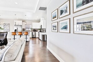 A modern kitchen with white cabinets, stainless steel appliances, and a central island. - Top Rated • Spotless & Spacious • Near Top Dining, Shopping & Entertainment (Meridian)