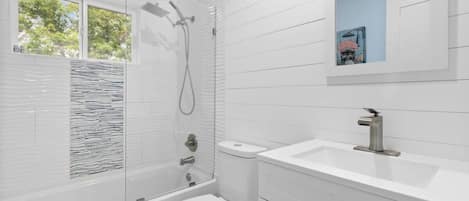 Shower, hair dryer, towels, shampoo