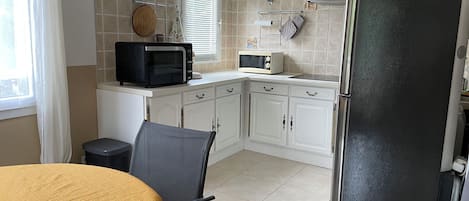 Enjoy meals at the dining table for two, surrounded by modern kitchen amenities.