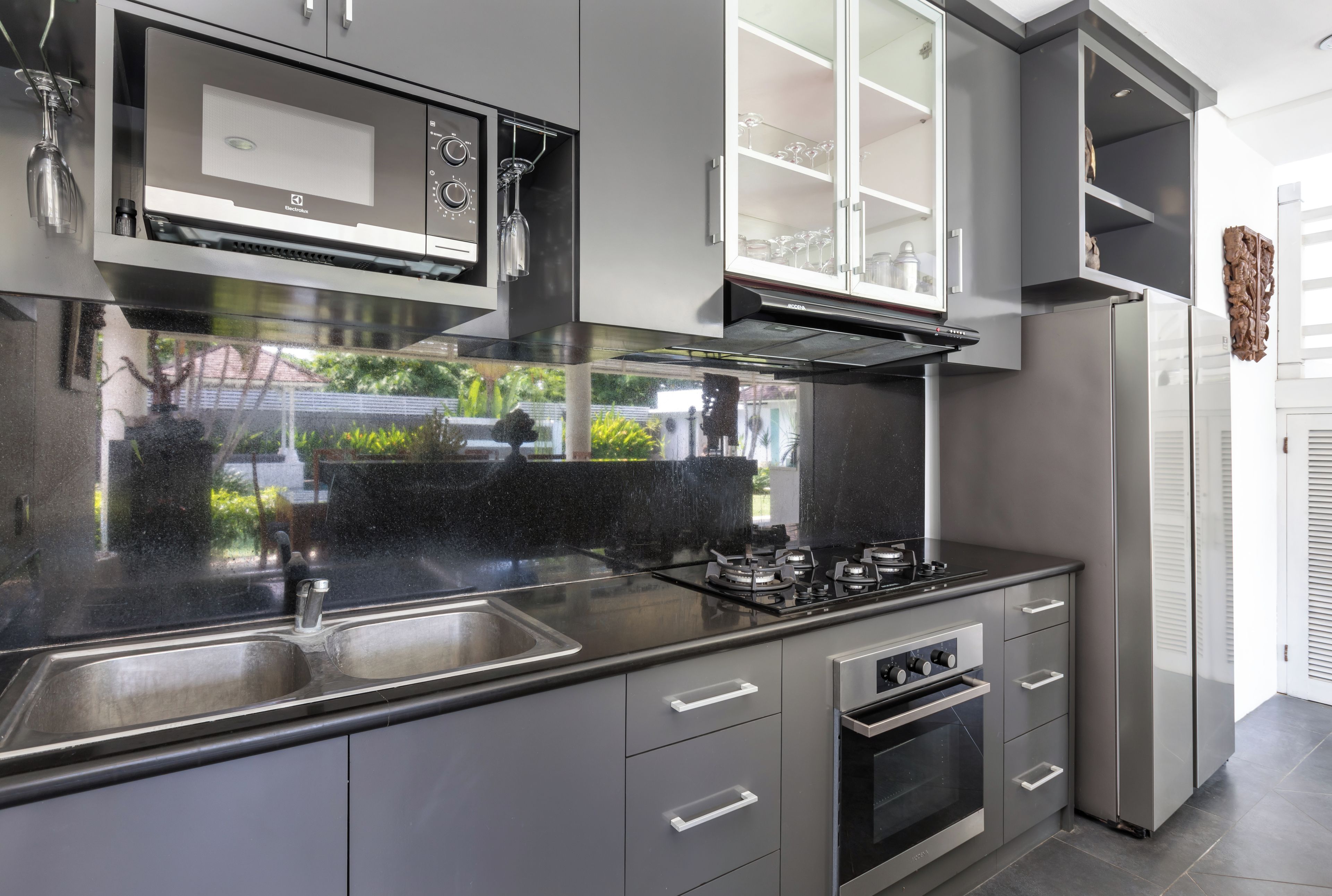 A modern kitchen with a gas stove, oven, and stainless steel appliances.