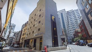 A modern hotel with a prominent 'HOTEL GATE' sign, featuring a unique architectural design with a large vertical entrance and a patterned facade. - Hotel Gate (Incheon)