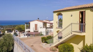 A coastal residential area with houses featuring balconies and a clear view of the sea. - Vacation home Alice by Interhome (Badesi)