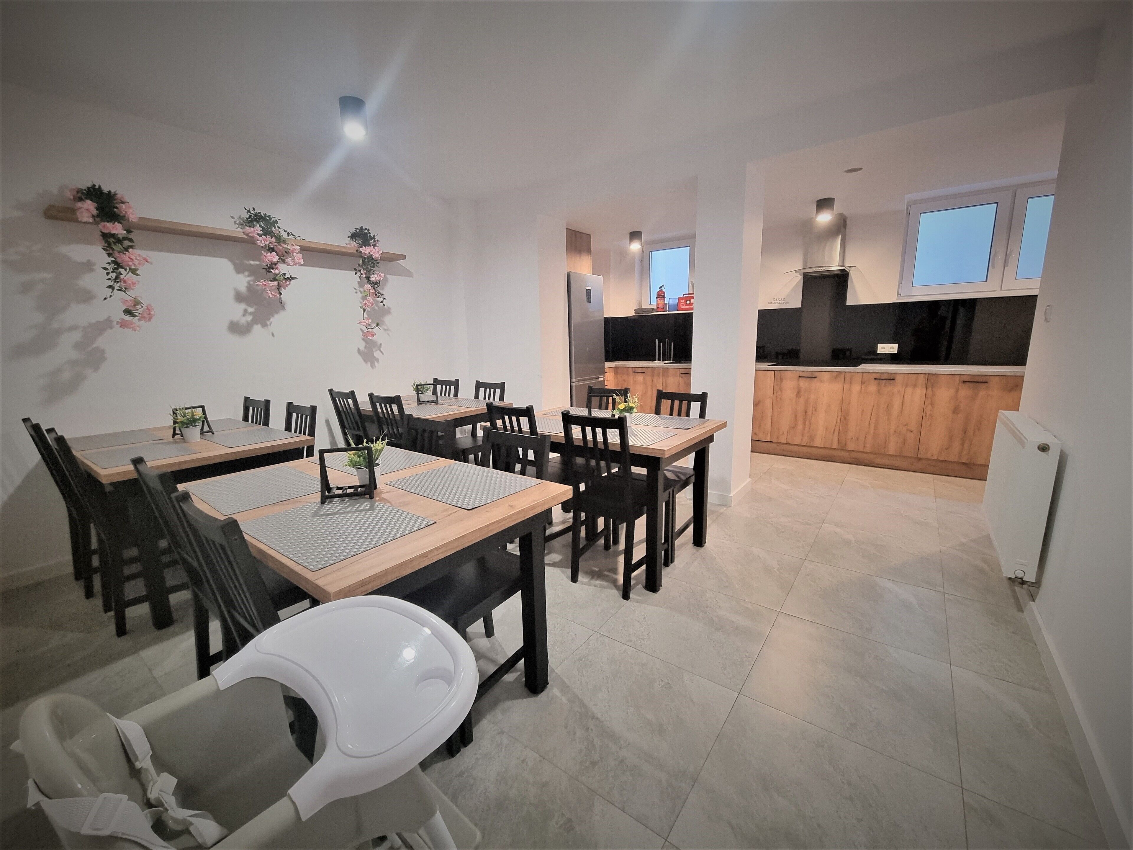 A modern kitchen with wooden cabinets and a black countertop.