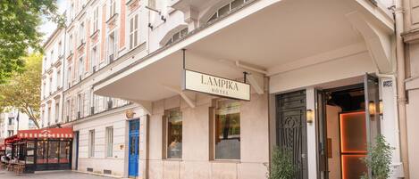 Entrada de hotel com uma placa que diz "LAMPIKA HOTEL".