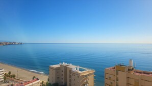 A coastal view with a beach and buildings.