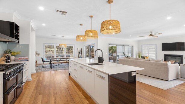 A modern kitchen with a central island, wooden flooring, and pendant lighting. - HUNTER DREAMING - THE VINTAGE HOLIDAY HOUSES (Pokolbin)
