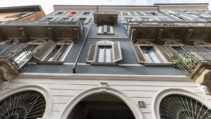 A building with multiple balconies, large arched windows, and a prominent number '50' on the facade. - nota-Mi - Domus Ticinese (Milan)