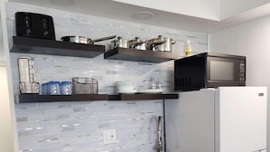 A compact kitchen with a stove, oven, microwave, and refrigerator. - Oceanfront Efficiency T604 (Myrtle Beach)