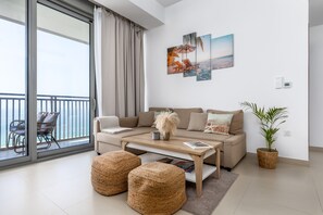 Elite Apartment | Living area | 50-inch Smart TV with cable channels - Waves Holiday Home - Jaw-Dropping Sea View From This Comfy Retreat (Dubai)