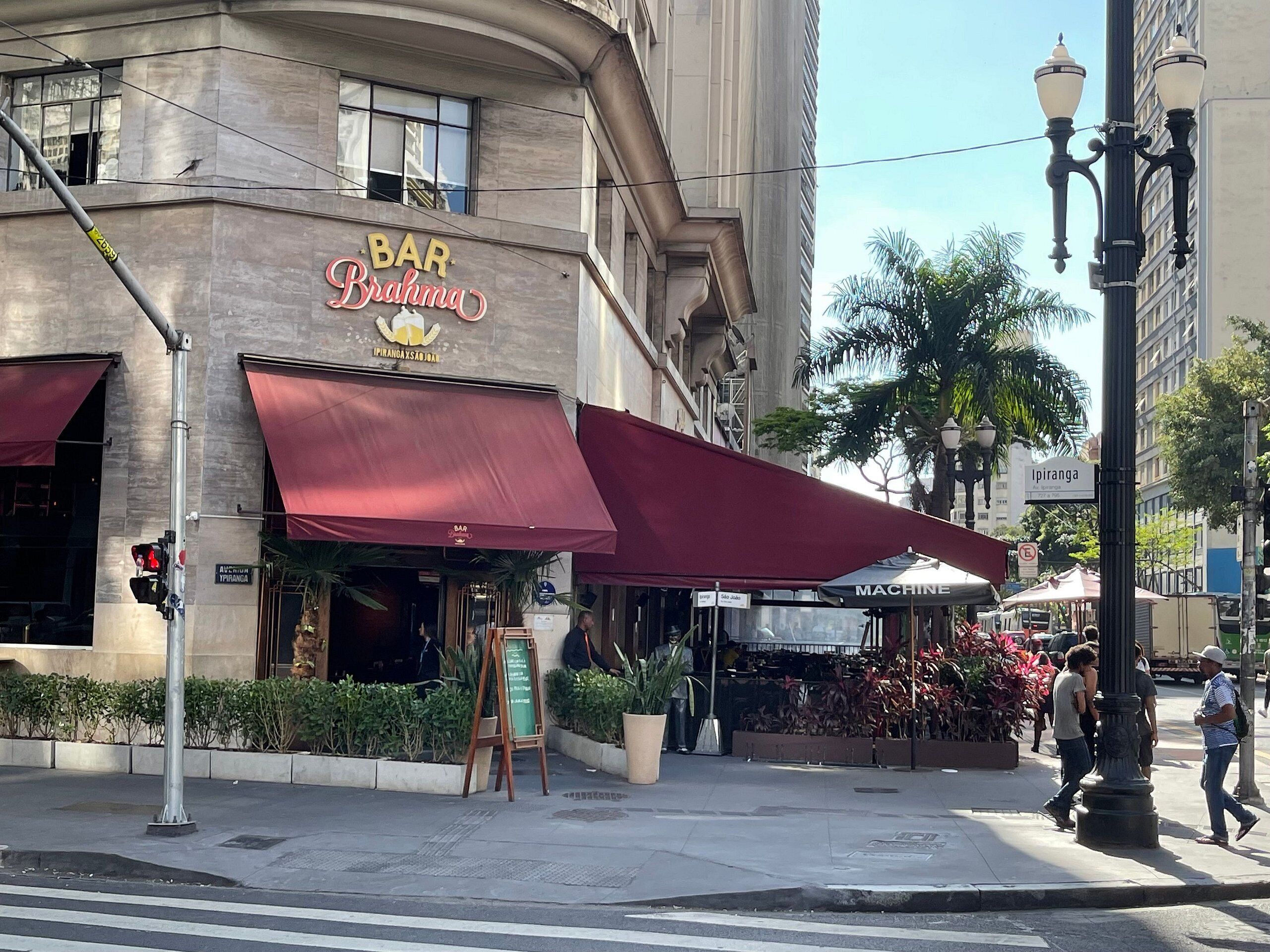 A building with a sign reading "BAR Brahma" and a red awning.