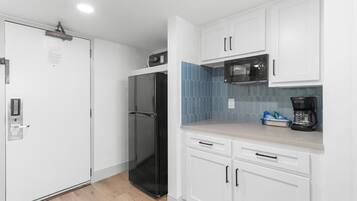 Fridge, microwave, coffee/tea maker, cookware/dishes/utensils