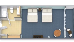 Et værelse med seng, et lille bord, en stol, toilet og bruseområde.