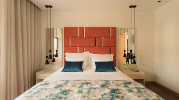 A hotel room with a bed, a bedside table, a nightstand, a mirror, and a window with curtains.