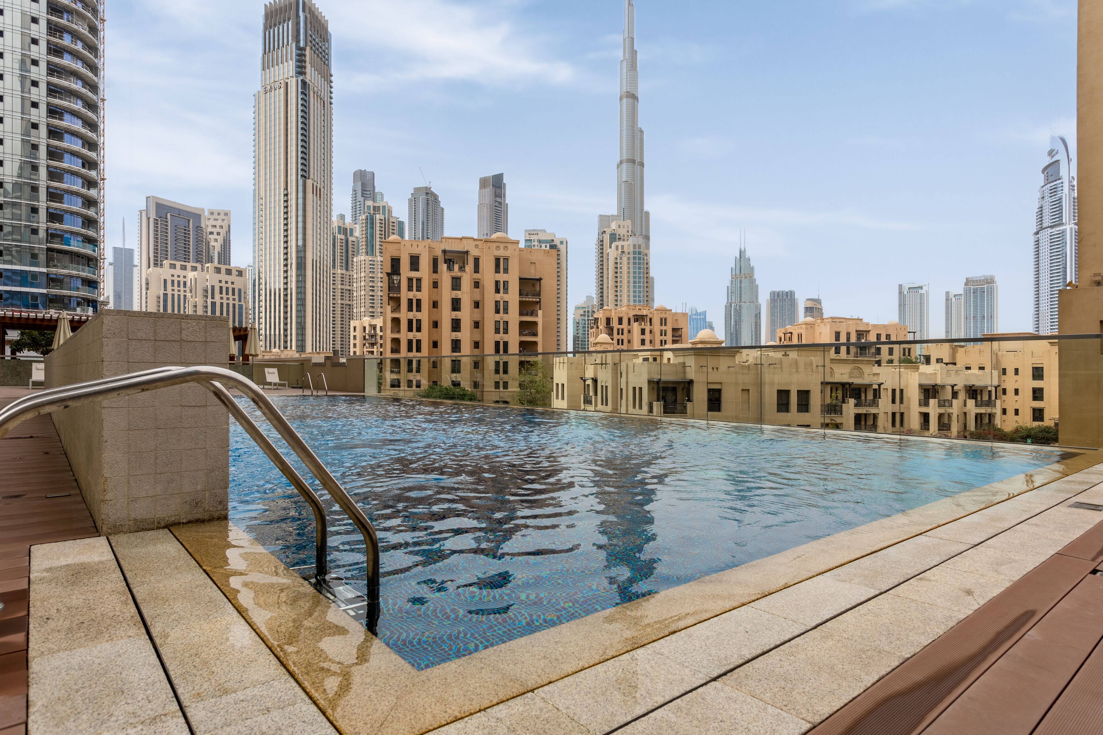 A rooftop pool with a city skyline in the background.