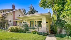 A two-story house with a front porch, a chimney, and a well-maintained lawn. - Lovely Salt Lake City Cottage w/ Outdoor Space! (Salt Lake City)