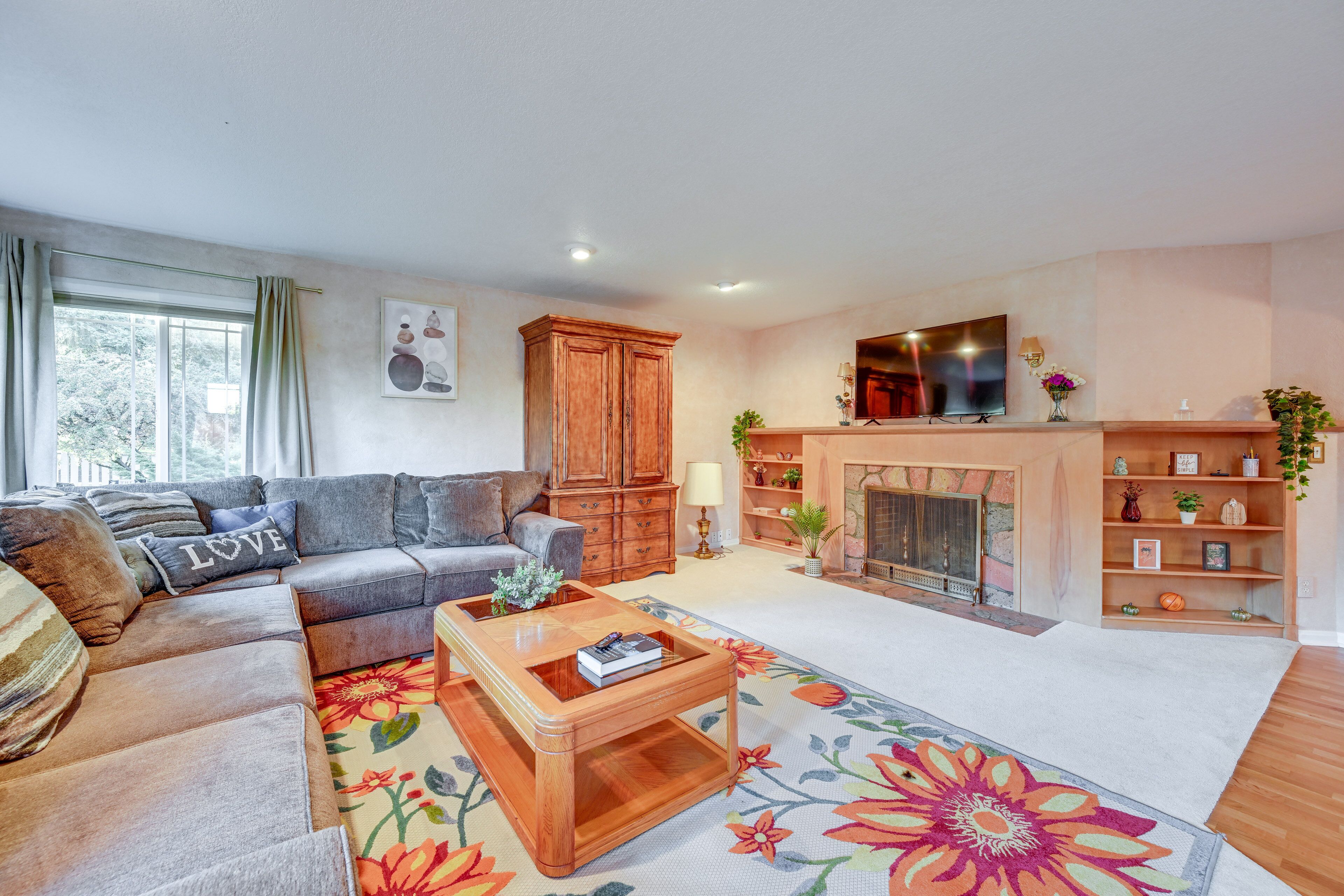 A living room with a sofa, coffee table, and fireplace.